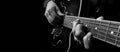 Guitarist hands and guitar close up. playing electric guitar. copy spaces. black and white. Royalty Free Stock Photo