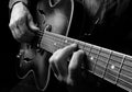 Guitarist hands and guitar close up. playing electric guitar. copy spaces.  black and white. Royalty Free Stock Photo