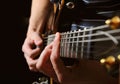 Guitarist hands playing guitar over black Royalty Free Stock Photo