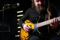 Guitarist man plays an electric guitar Close-up at studio Royalty Free Stock Photo