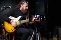 Guitarist man plays an electric guitar Close-up at studio Royalty Free Stock Photo