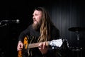 Guitarist man plays an electric guitar Close-up at studio Royalty Free Stock Photo