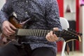 Guitarist playing electric guitar, close-up. Royalty Free Stock Photo