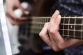 Guitarist playing electric guitar, close-up. Royalty Free Stock Photo