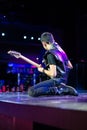 Guitarist Playing Electric Guitar Kneeling on Stage