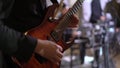 Guitarist playing electric guitar music on stage at rock concert indoors. Royalty Free Stock Photo