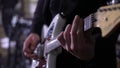 Guitarist playing electric guitar music on stage at rock concert indoors. Royalty Free Stock Photo