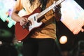 Guitarist playing electricity guitar on concert stage. Entertainment and music concept