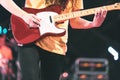 Guitarist playing electricity guitar on concert stage. Enterment and music concept