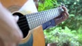 Guitarist playing his guitar. Focus on his fingers playing his chords.