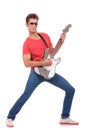 Guitarist plays & looks at you Royalty Free Stock Photo