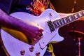 Guitarist Plays a Solo Live on Stage. Man Performs Blues Rock Songs with the White Electric Guitar at a Music Festival