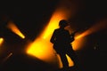 Guitarist plays solo. silhouette of guitar player in action on music stage. popular music rock band performs on stage Royalty Free Stock Photo