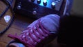 Guitarist pushing the guitar pedal buttons with foot