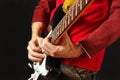 Guitarist put fingers for chords on electric guitar on black background Royalty Free Stock Photo