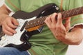 Guitarist put fingers for chords on electric guitar close up Royalty Free Stock Photo
