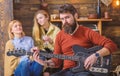 Guitarist rehearsing new show. Bearded man entertaining his wife and daughter with lovely tunes. Rock musician on