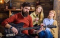 Guitarist rehearsing new show. Bearded man entertaining his wife and daughter with lovely tunes. Rock musician on