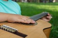 The guitarist& x27;s hand lies on the strings of a classical acoustic wooden guitar Royalty Free Stock Photo