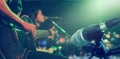 Guitarist on stage with microphone for background, soft and blur