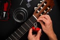 Guitarist trims new strings with pliers during a classical guitar restringing process. Cutting Guitar Strings with Pliers Royalty Free Stock Photo