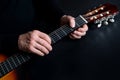 Guitarist tunes instrument, man plays the guitar, close-up hands, the concept of creativity, learning to play musical instruments