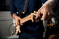 Guitarist tuning electric guitar close-up