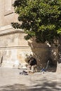 Guitarist under a tree, next to the door of the Church of the Sa