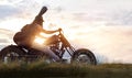 Guitarist woman riding a motorcycle on the countryside road