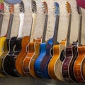 Guitars hanging in row on the wall Royalty Free Stock Photo