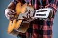 Guitars and strings. Man playing guitar, holding an acoustic guitar in his hands. Music concept. Guitarist plays. Play Royalty Free Stock Photo