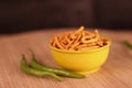 Gujarati local food Gadhiya with green pepper chili on wooden table,Chivda, Farsan, Namkin