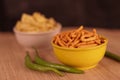 Gujarati local food Gadhiya with green pepper chili on wooden table,Chivda, Farsan, Namkin