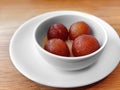 Gulab jamun recipe, soft delicious berry sized balls made of milk solids, flour and a leavening agent, serving on white bowl.