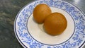 Gulab Jamun serving on white ceramic plate. Popular Indian Sweet food made up of milk and sugar. Selective focus