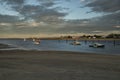 Gulf of the atlantic ocean at sunset. scarlet fishing boats in the water and houses on the coast. Royalty Free Stock Photo