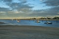 gulf of the atlantic ocean at sunset. scarlet fishing boats in the water and houses on the coast. Royalty Free Stock Photo