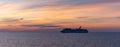 Gulf of Mexico - April 5, 2020: Panoramic shot of Carnival Valor drifting at sea at sunset. Beautiful orange sky in the background