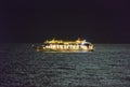 Gulf of Mexico - April 13, 2020: A Royal Caribbean cruise ship drifting in the Gulf of Mexico at night. Moon light reflecting off