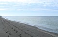 Gulf of Mexico clouds and beach footprints after sunrise