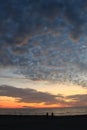 Awesome Gulf of Mexico sunset with silhouettes of beachgoers enjoying the view.