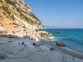 Gulf of Orosei, Sardinia, Italy, September 8, 2020: Cala Goloritze beach with bathing tourist people. White pebbles