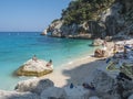 Gulf of Orosei, Sardinia, Italy, September 8, 2020: A view of Cala Goloritze beach with bathing tourist people. White