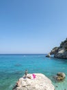 Gulf of Orosei, Sardinia, Italy, September 8, 2020: A view of yopung woman sunbathing at Cala Goloritze beach with