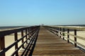 Gulf view of a public pier stretching towards a cloudless blue sky