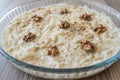 Gullac, a Delightful Turkish Traditional Milk Dessert with Walnut, Displayed on a Wooden Background