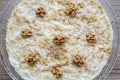 Gullac, Turkish Traditional Milk Dessert with Walnut on a Wooden Background