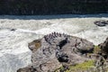 Gullfoss, Iceland - July 9, 2023: Tourists view Gullfoss waterfall from water-level at a viewing point at the tourist attraction