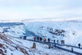 GULLFOSS, ICELAND - March 4, 2020: Tourists at the observation deck look at Gullfoss waterfall in Iceland