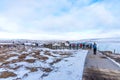 GULLFOSS, ICELAND - March 4, 2020: Tourists at the observation deck look at Gullfoss waterfall in Iceland